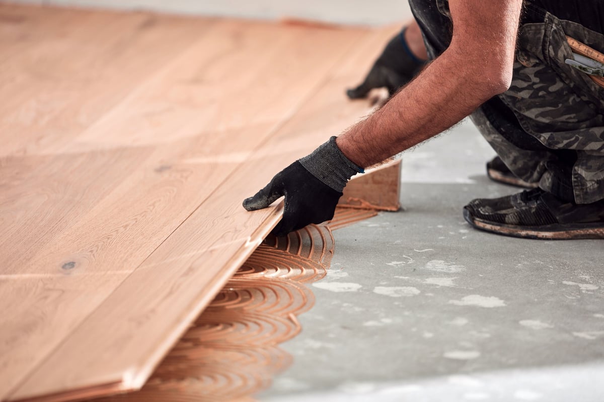 Professional handyman installing laminate flooring